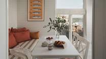 A sweet dining nook welcomes flavoursome feasts with a backdrop of ocean blues
