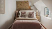 Promising soothing slumber, the second bedroom showcases a comfortable Loaf double bed