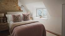 Complemented by cushions and throws in rosy hues