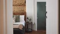 The first bedroom invites restful nights and leisurely lie-ins