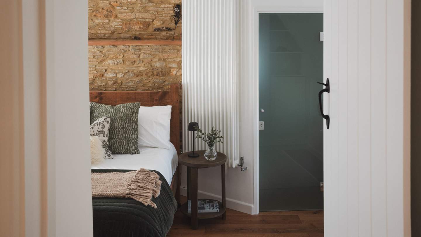 The first bedroom invites restful nights and leisurely lie-ins