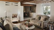 Traditional charm and contemporary comforts blend seamlessly alongside exposed beams, honey-hued stonework and original features