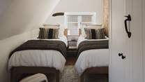 The third bedroom welcomes with beautifully appointed twin beds