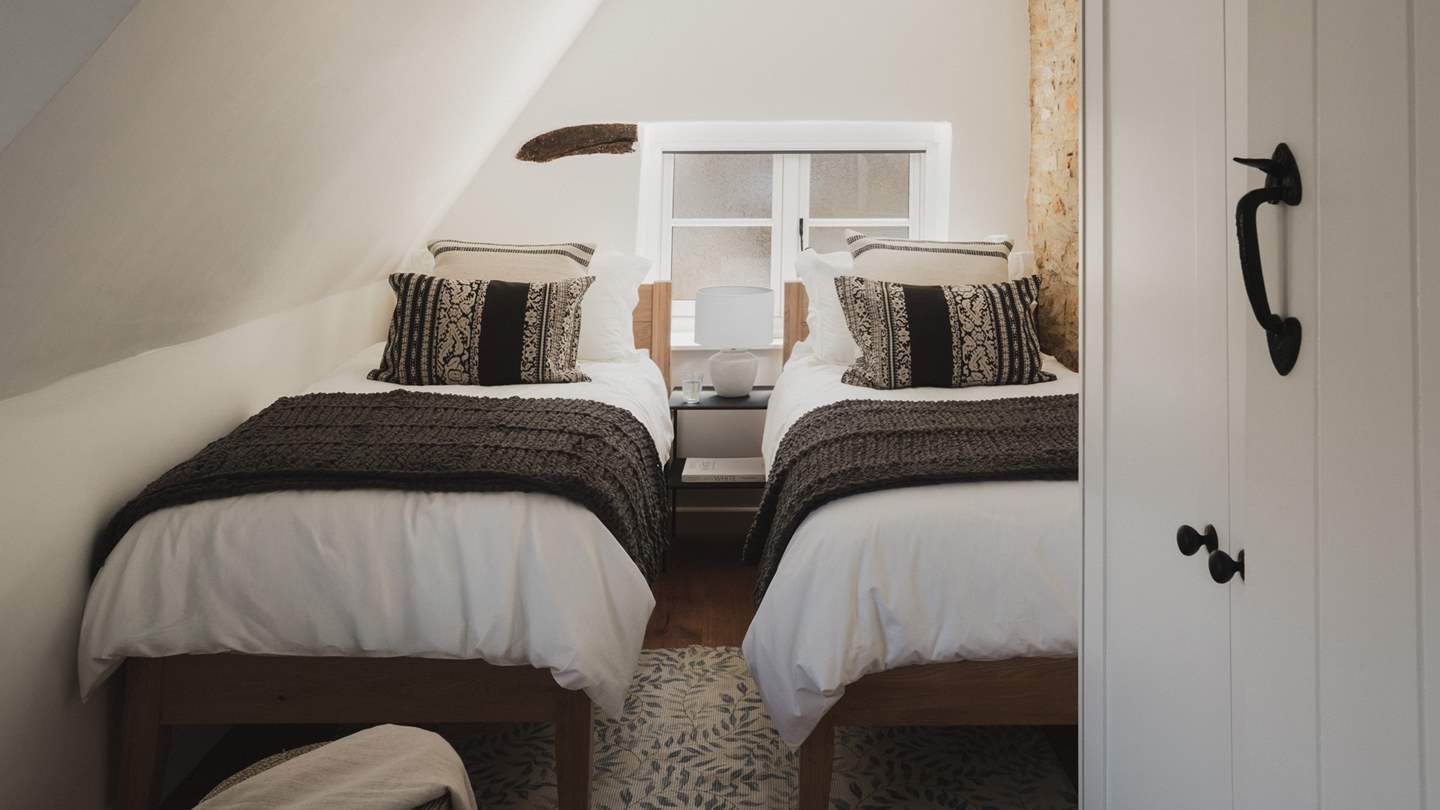 The third bedroom welcomes with beautifully appointed twin beds