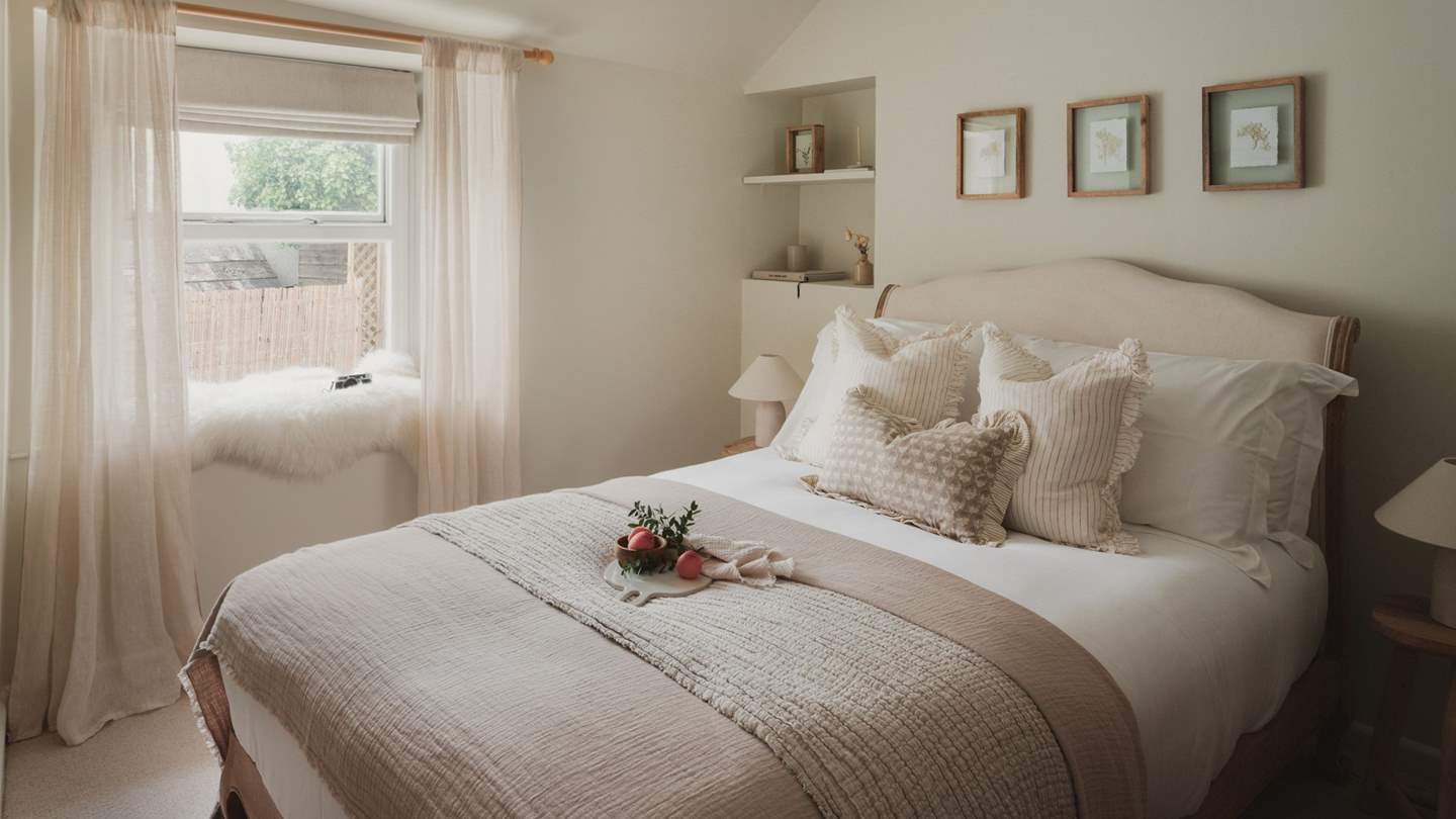 A neutral palette is accompanied by a Loaf double bed adorned with cosy linens and throws