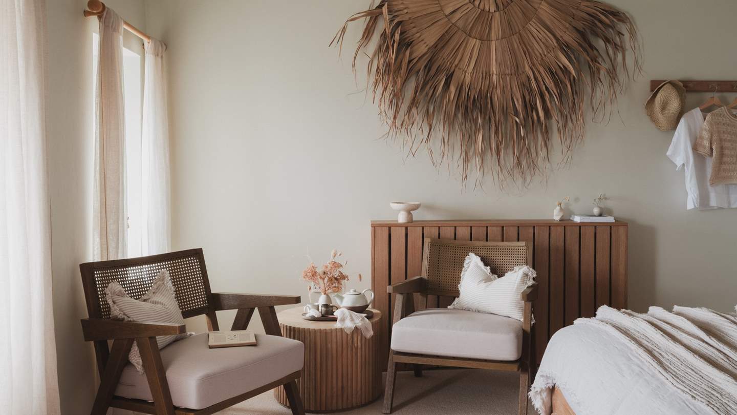 Lose time in the bedroom nook, where a side table and rattan lounge chairs provide the perfect backdrop for your morning coffee
