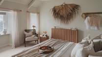 A super king Feather and Black bed is dressed in cloud-like linens