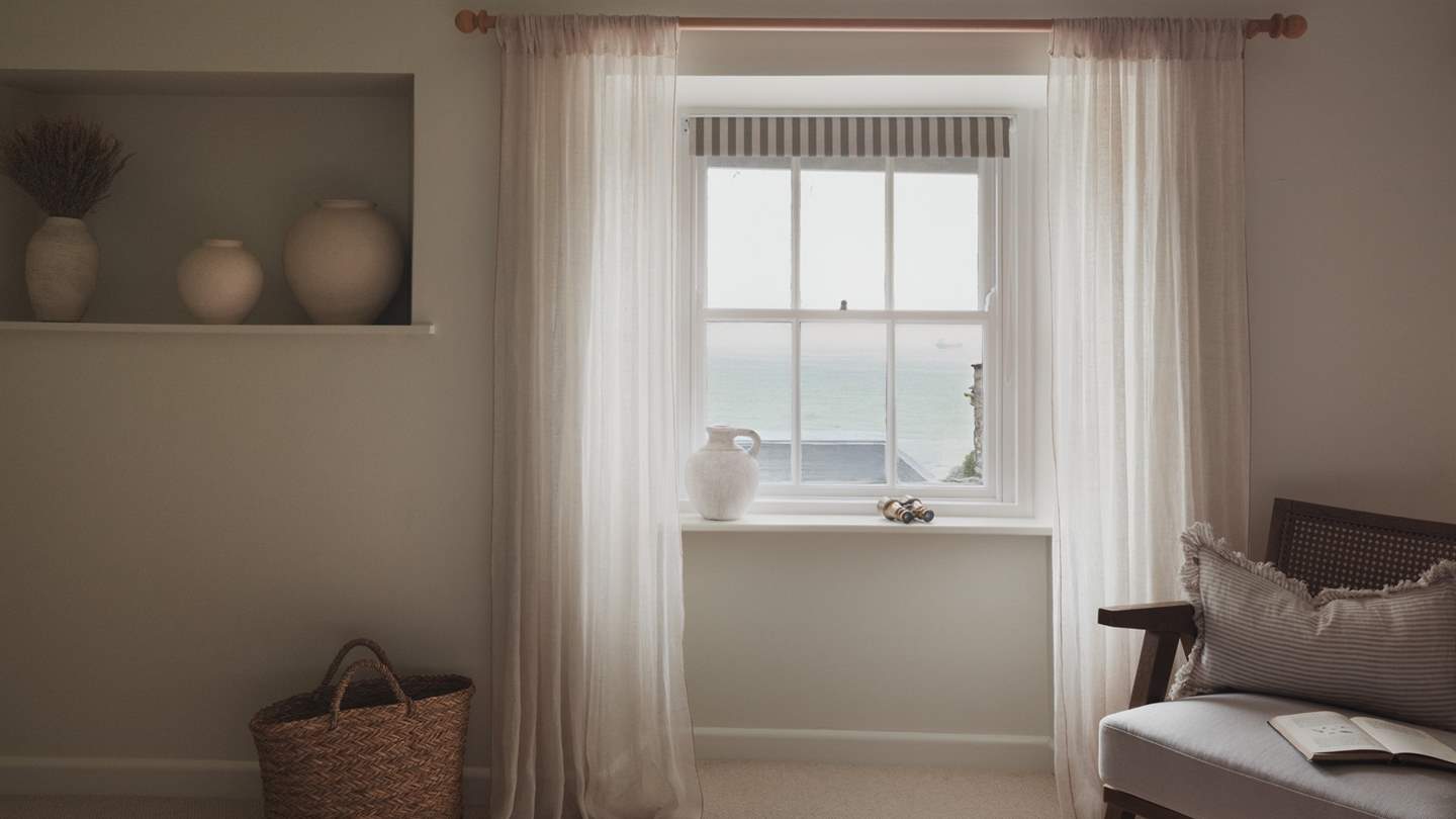 Admire soothing sea glimpses from original sash windows...