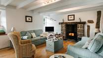 A spacious and bright sitting room with roaring wood burner and oak floors intermingled with original granite from the farmhouse it once was