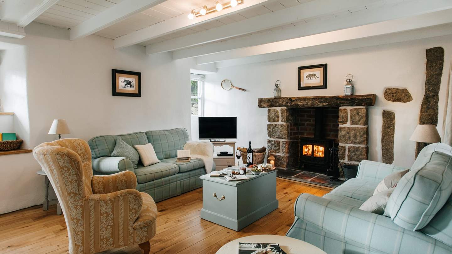 Promising, white-washed cottage beams, oak floors and exposed granite, the spacious sitting room is a heavenly place to gather in front of the wood burning stove