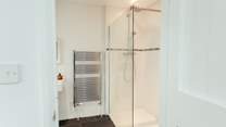 You'll find a large modern wet room with slate floor downstairs