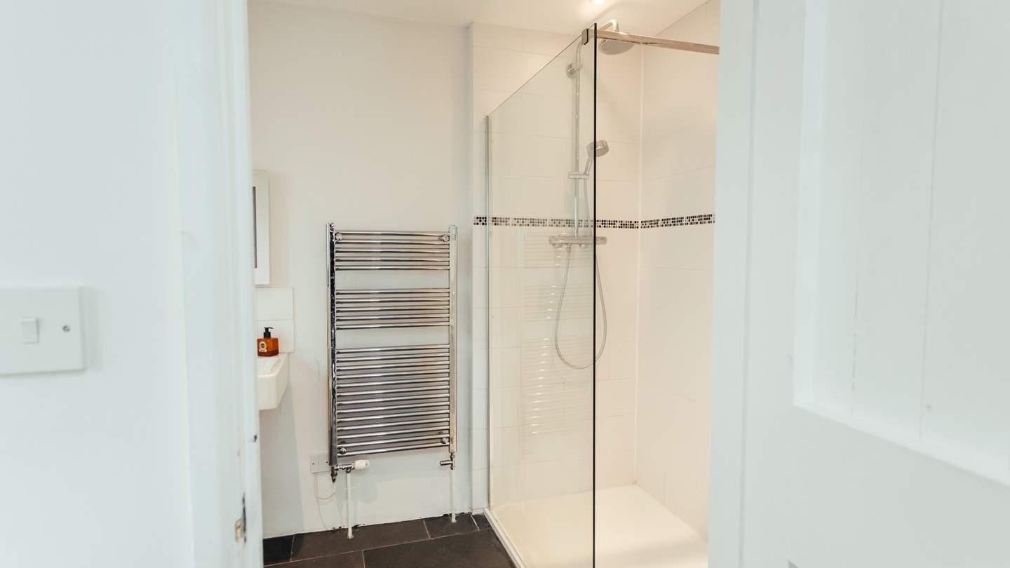 You'll find a large modern wet room with slate floor downstairs