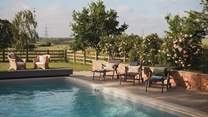 An array of sun loungers await for golden hour cocktails beneath gilded skies