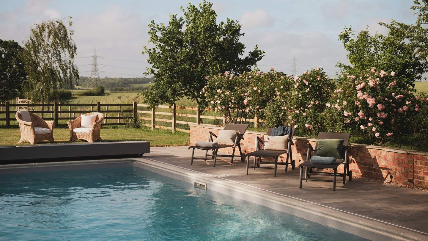 An array of sun loungers await for golden hour cocktails beneath gilded skies
