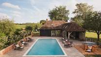 Immerse yourself in the glistening outdoor pool at Demeter