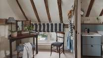 In this airy bedroom, you'll find a dressing table and chest of drawers for storing belongings