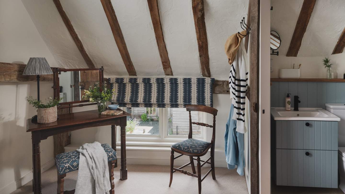 In this airy bedroom, you'll find a dressing table and chest of drawers for storing belongings
