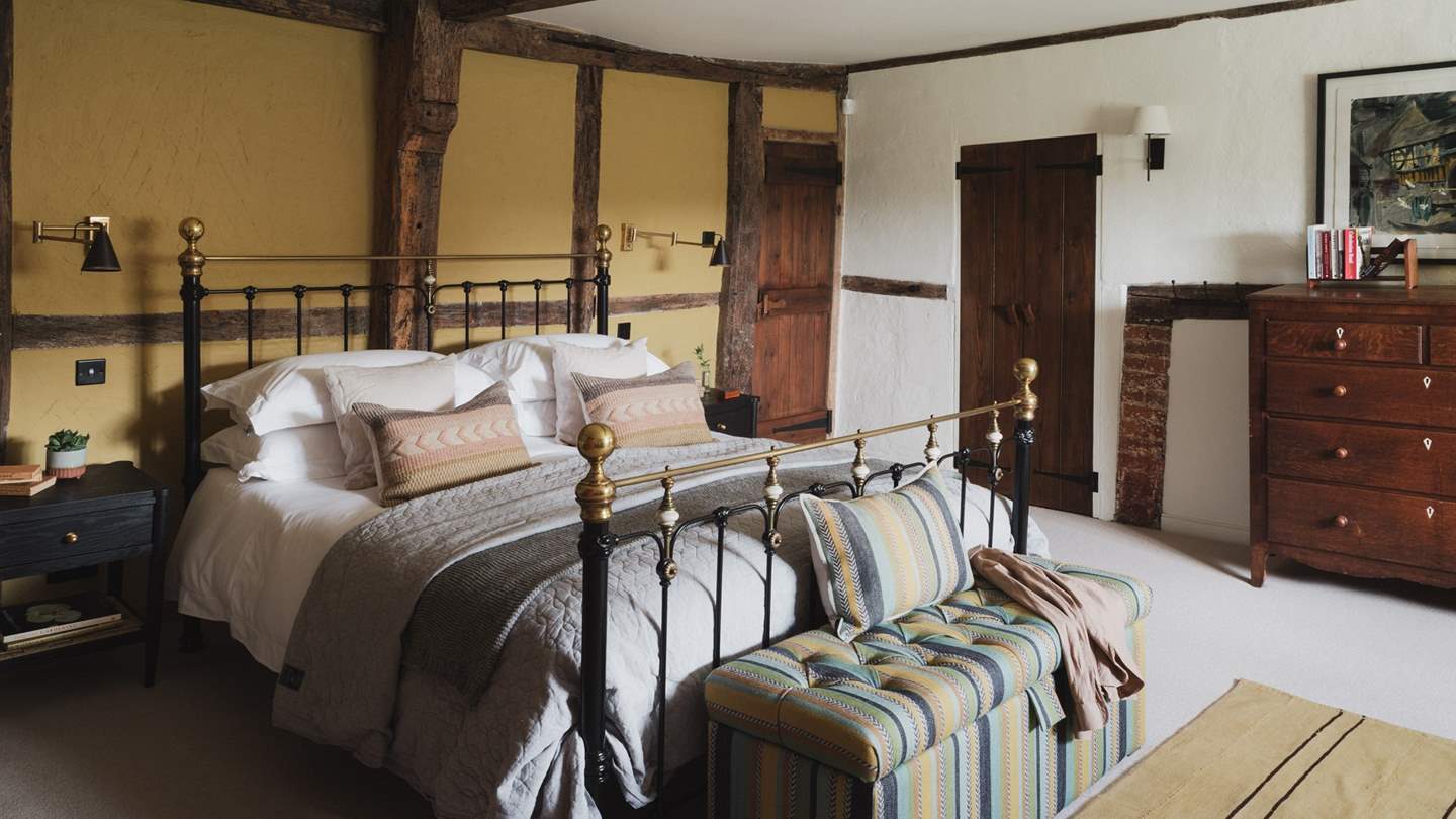 Uncover the first bedroom, home to a super king brass bed enswathed in soft linens
