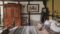 Shades of ochre adorn one wall in this inviting master suite