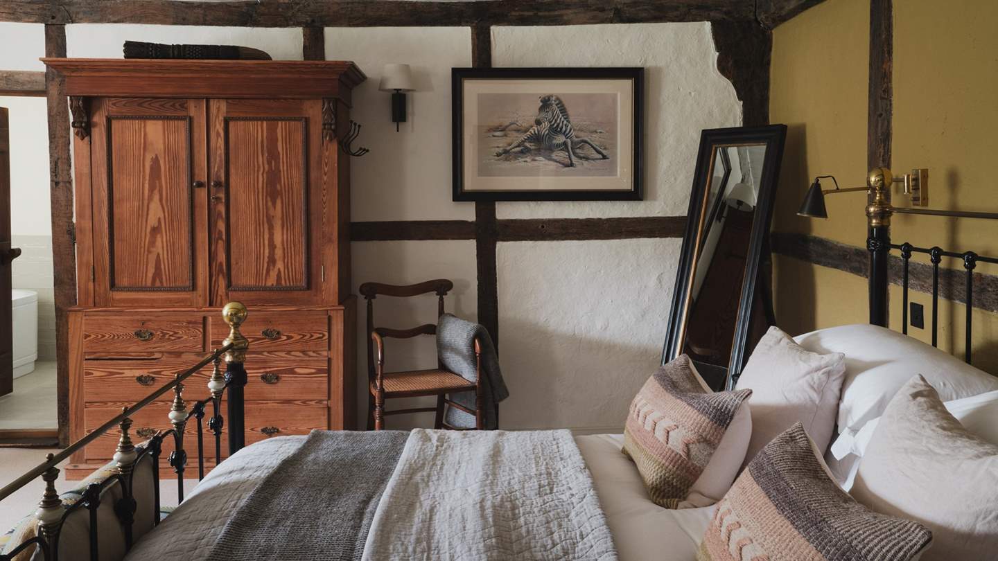 Shades of ochre adorn one wall in this inviting master suite