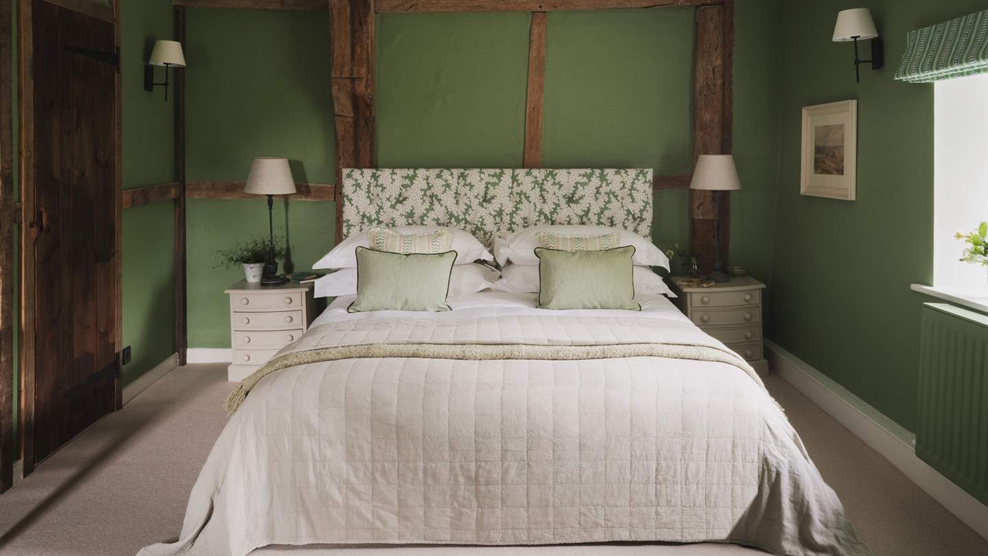 This space features a super king bed, along with two antique armchairs for relaxed contemplation