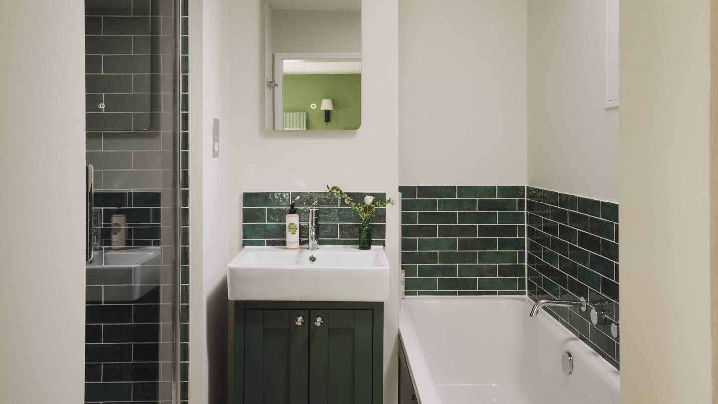 You'll find a shower and bath in the forest green en suite