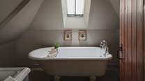 This bedroom also enjoys an ensuite bathroom, complete with a bath and hand shower