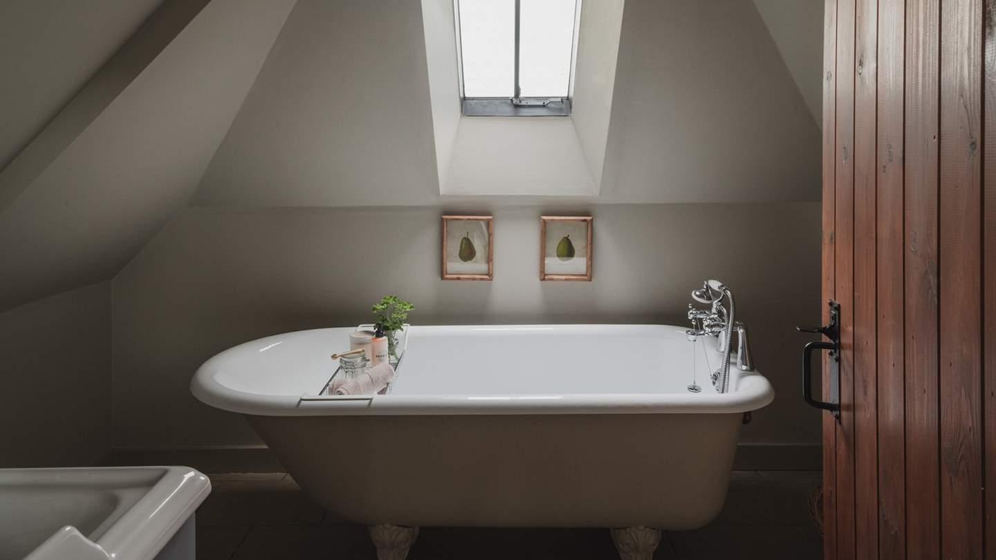 This bedroom also enjoys an ensuite bathroom, complete with a bath and hand shower
