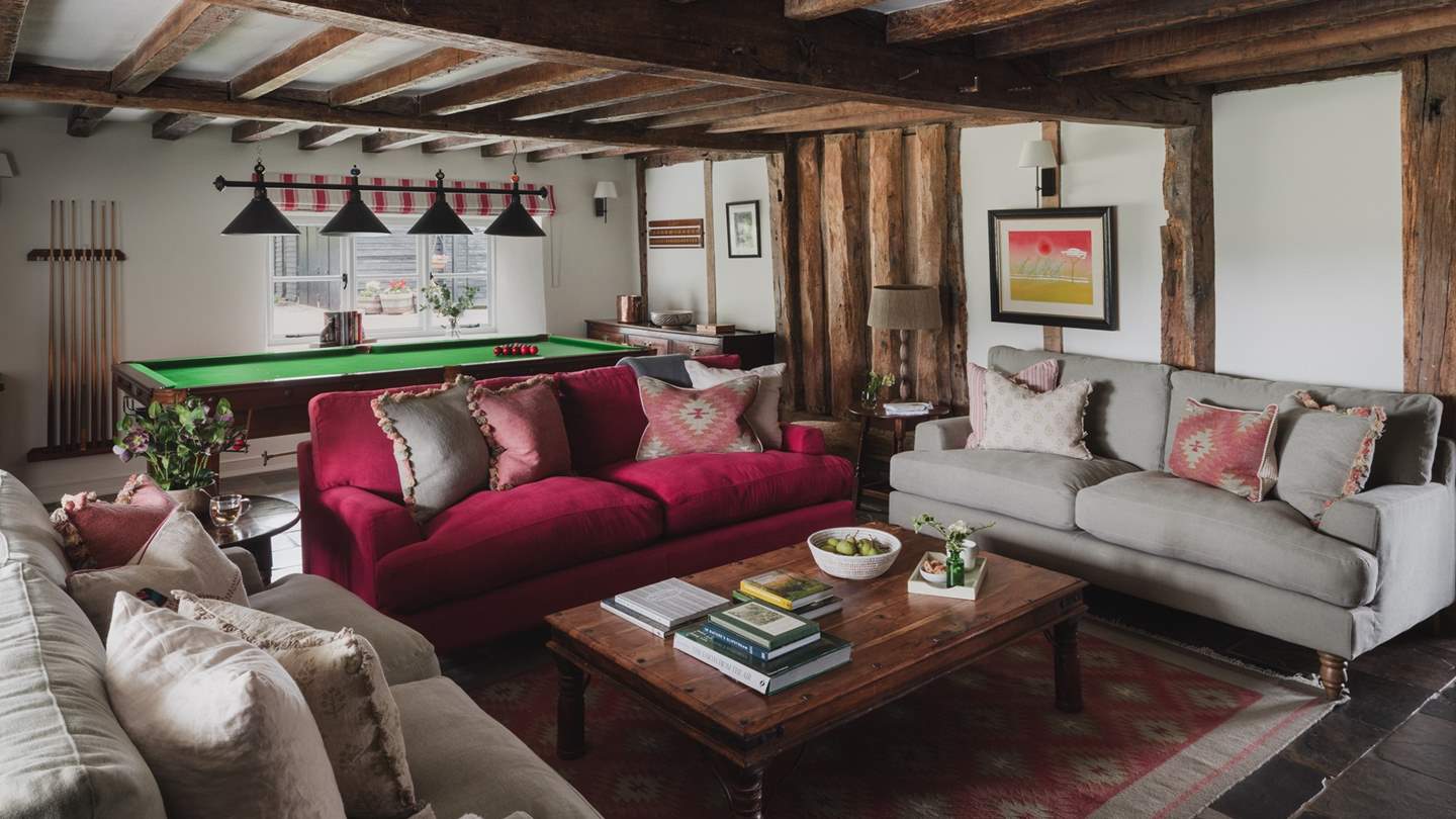 Offering sumptuous space to recline are three sofas and striped occasional chairs
