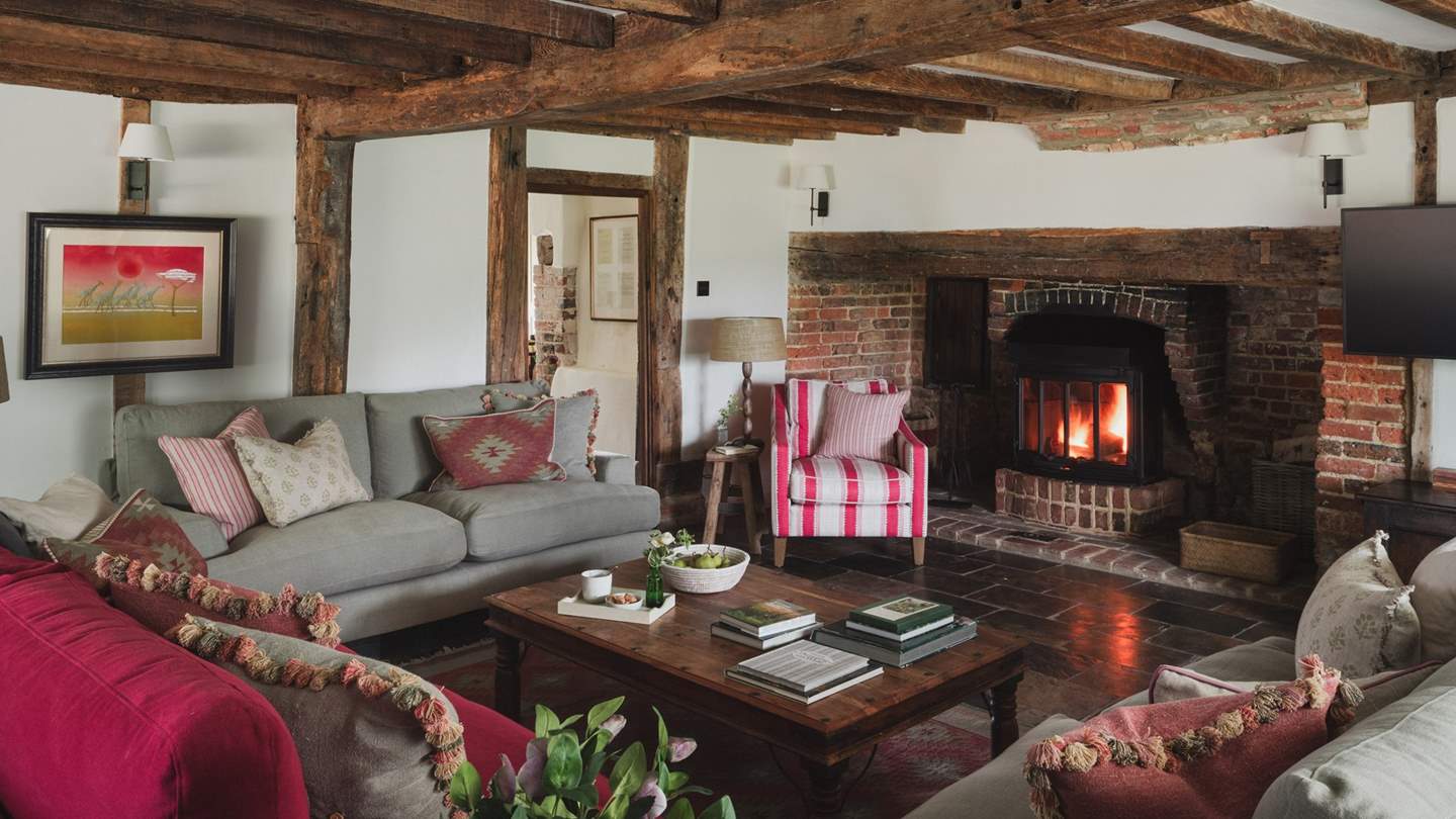 The main living area entwines quintessential English charm with French farmhouse living, where a large inglenook fireplace awaits with a wood burning stove
