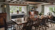 A table is complete with antique wheelback dining chairs for twelve guests