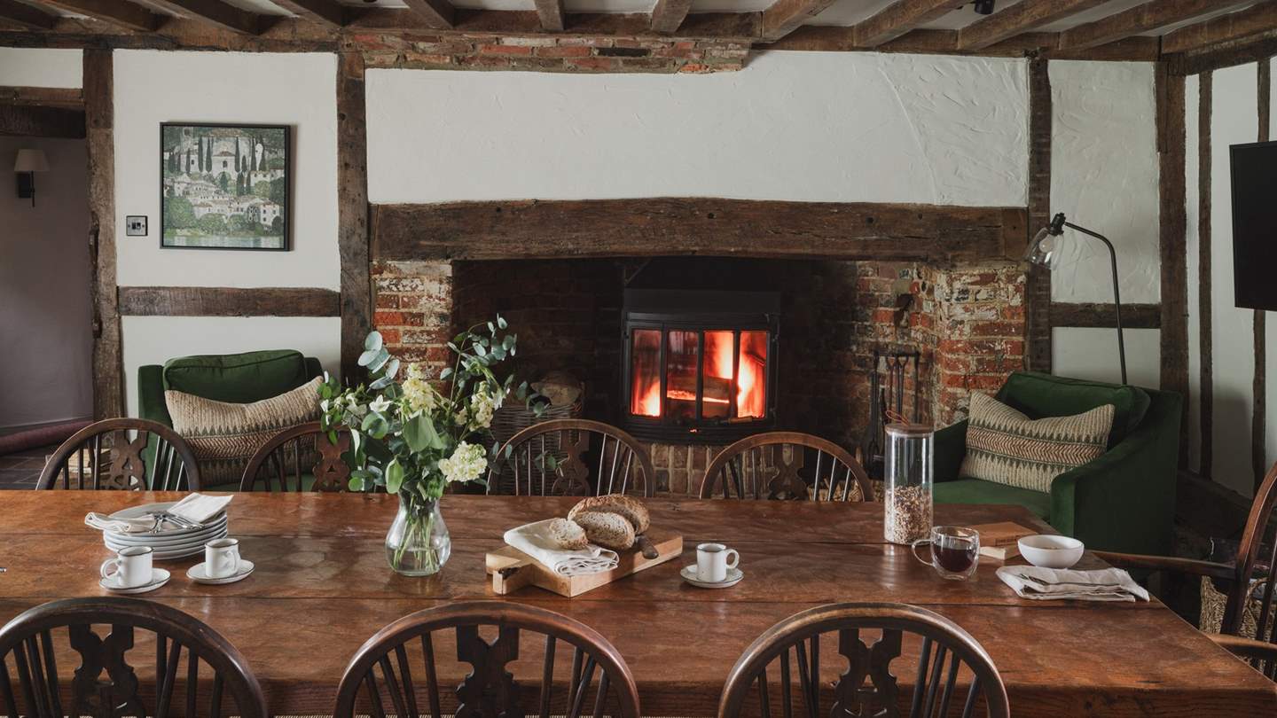 Seek quietude beside flickering flames, where two armchairs offer comfort and calm throughout the day