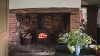 Discover a third wood burning stove, set within a red brick inglenook fireplace 