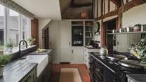 Exuding winsome appeal with characterful ceilings and original beams, the kitchen offers a welcoming space to craft meals