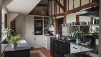 Handcrafted cabinetry elegantly integrates into each space, complemented by an array of appliances, including an Aga