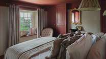 Centred around a sumptuous king-size bed, dressed in comforting linens