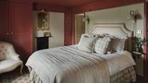 Dressed in a palette of blush hues, the master bedroom exudes understated elegance