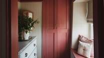 A wardrobe and chest of drawers offer ample storage