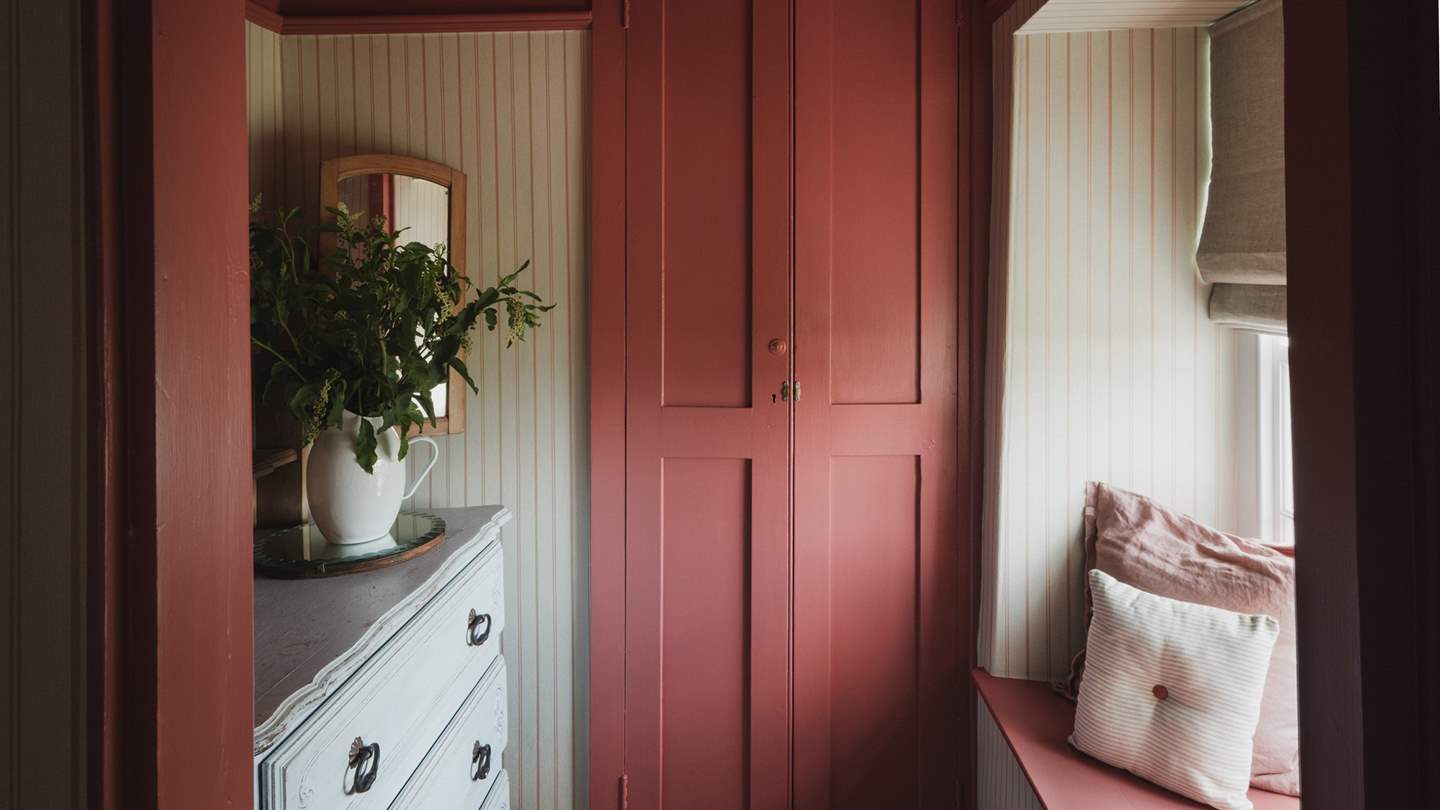 A wardrobe and chest of drawers offer ample storage