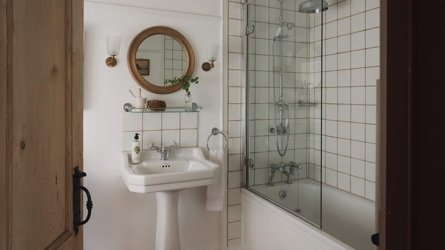 The ensuite bathroom invites a serene space for refreshing rainfall mornings and indulgent soaks after days spent exploring