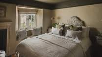 Beautifully styled in soft, earthy tones, the second bedroom offers a serene sanctuary