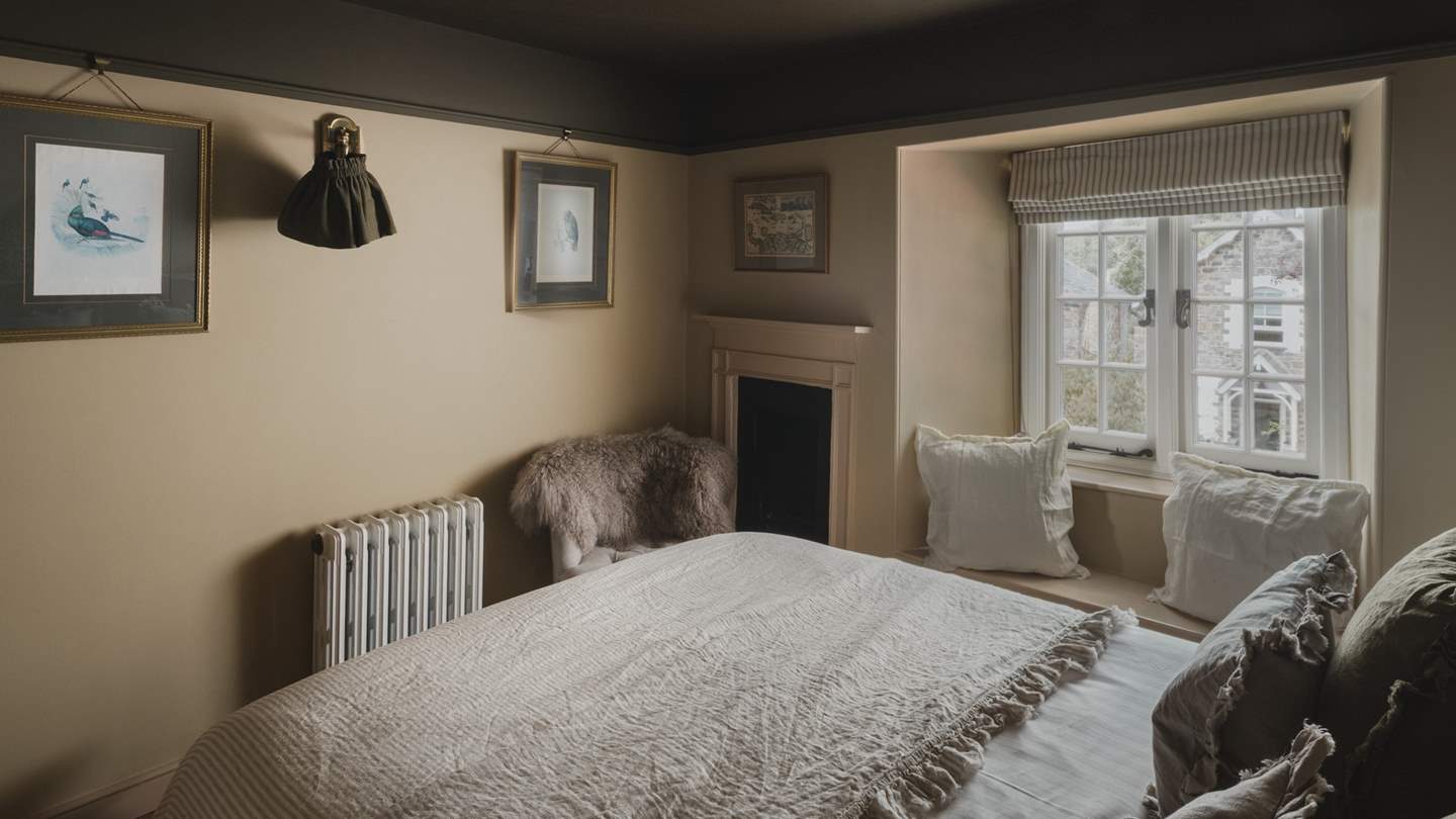 The charming window seat creates a cosy nook for curling up with a captivating read