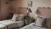 With dreamy pinstripe headboards, the twin beds can be set as a super-king for flexible sleeping arrangements