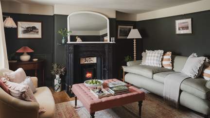 Two plush Rowen & Wren sofas positioned either side of a bijou wood burner