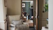 A comfortable armchair and charming window seat offer additional spots to unwind