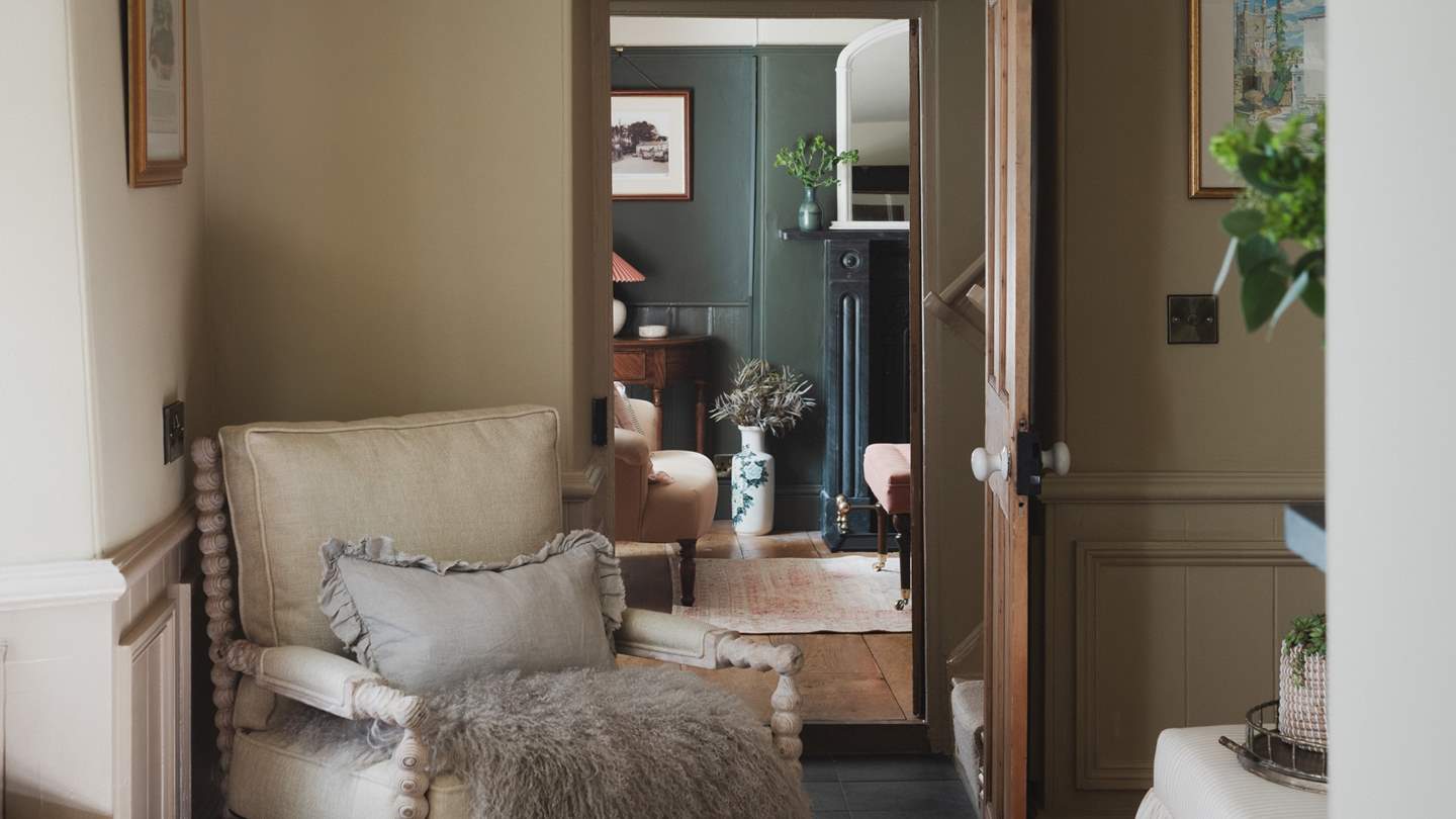 A comfortable armchair and charming window seat offer additional spots to unwind
