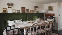 With a rustic dining table, complementary chairs and a dining bench 