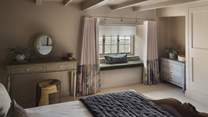 Featuring a super king bed, you’ll also find a dressing table with a stool