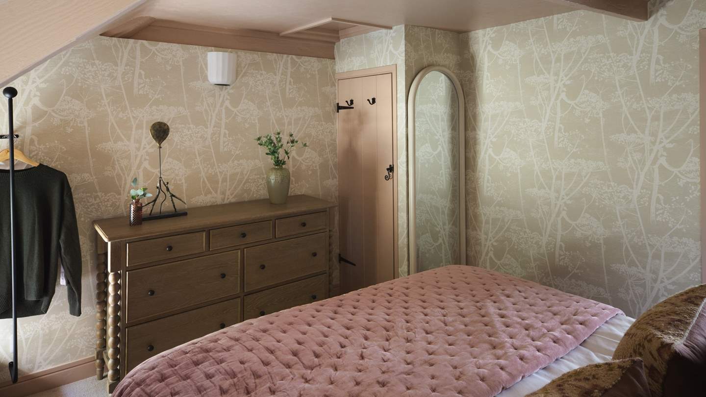 For storage, discover a chest of drawers and a small rail for hanging garments