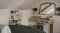You’ll find two bedside tables, wardrobe, chest of drawers for storing your belongings in this elegant space